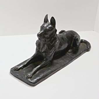 german shepherd figurine lying down
