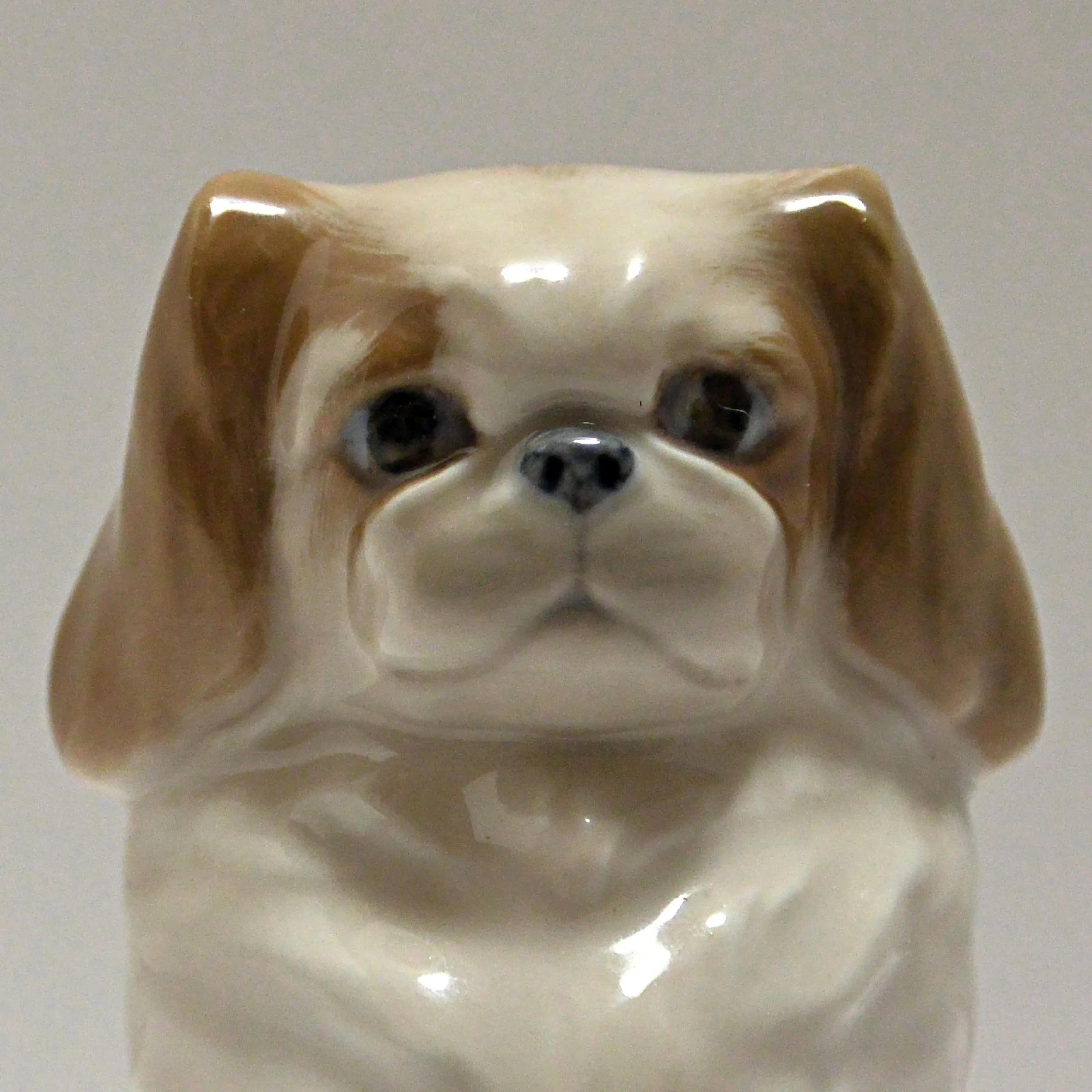Royal Copenhagen Pekingese porcelain dog figurine, hand-painted underglaze with signature blue-grey palette